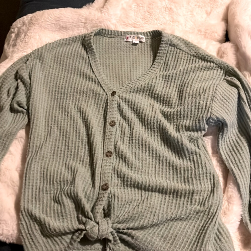 Green buttoned up shirt.